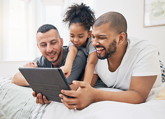 Image showing Gay family, tablet and child on a bed at home for e learning, watch video and education on internet. Adoption, lgbt men or parents with a happy kid and technology for streaming movies, games or app