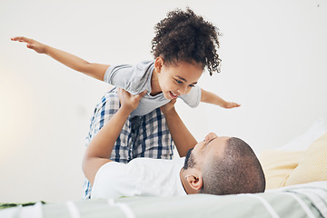 Image showing Happy, fun and father with girl on bed playing, bonding and airplane game for dad with child in home. Family, love and playful energy, man holding daughter in air and laughing in bedroom together.