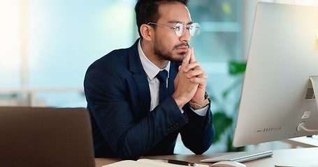 Image showing Business man analyzing a project strategy on a computer screen while working in an office. Serious and focused corporate professional thinking of solutions while considering ideas, choices and plans