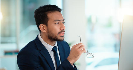 Image showing Stressed web developer suffering with mental block while trying to code on a computer in his office. Frustrated data scientist struggling with fatigue and feeling the pressure to hit his deadline