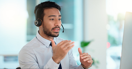 Image showing Call center agent consulting a buyer via video call in an office. A young friendly sales man talking to a client in a virtual meeting. A male customer service employee advising a consumer