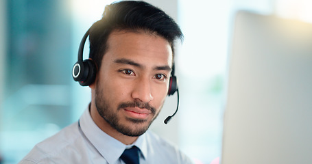 Image showing Call center agent talking and listening to a client on a headset while working in an office. Confident and reassuring salesman consulting and operating a helpdesk for customer service and support