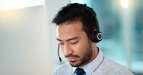 Image showing Call center agent talking and listening to a client on a headset while working in an office. Confident and reassuring salesman consulting and operating a helpdesk for customer service and support