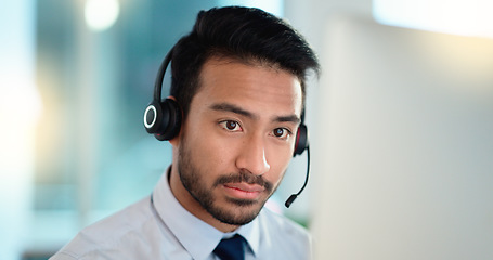 Image showing Call center agent talking and listening to a client on a headset while working in an office. Confident and reassuring salesman consulting and operating a helpdesk for customer service and support