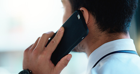 Image showing Business man talking on a phone call in an office. Closeup of corporate professional and entrepreneur from the back networking to build a successful empire. Communicating plans and deals with clients