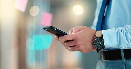 Image showing Businessman texting an email on his phone in a modern office. Corporate worker schedule a meeting with an instant business text message app. Closeup of trendy man sharing ideas online on social media