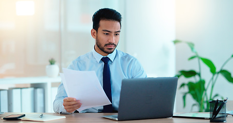 Image showing Young man working on his laptop in an office frustrated, stressed and angry about a bad sales report after a marketing campaign. Business manager upset and annoyed that he didnt hit his deadline