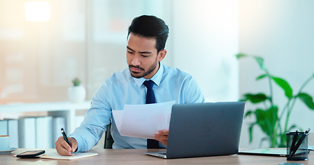 Image showing Lawyer and attorney working on corporate plans and compiling legal reports for a case at his desk. Business man and project manager reading and writing notes while working on a laptop in an office