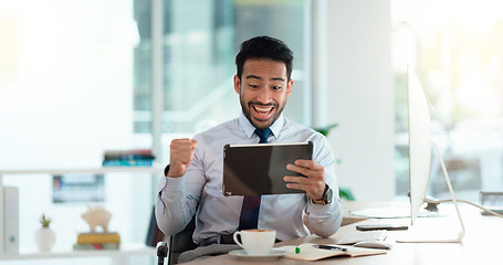 Image showing Successful and excited business man cheering with joy while working on digital tablet in an office. Happy trader and banker celebrating victory after reading good news about an exciting deal or bonus