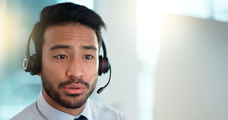 Image showing Call centre agent wearing headset giving great customer support service via email at his desk. Confident young sales representative making a sale at his helpdesk in the office. Operator sends invoice