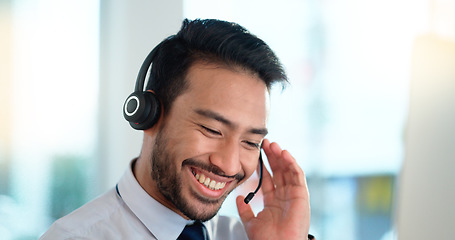 Image showing Call center agent consulting a buyer via video call in an office. A young friendly sales man talking to a client in a virtual meeting. A male customer service employee advising a consumer