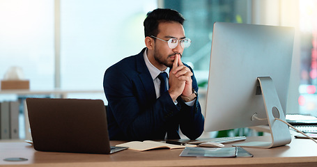 Image showing Business man analyzing a project strategy on a computer screen while working in an office. Serious and focused corporate professional thinking of solutions while considering ideas, choices and plans