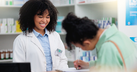 Image showing Pharmacist helping a customer in a pharmacy. Woman signing medical paperwork to collect over the counter and prescription medication from a friendly healthcare worker in a chemist or dispensary