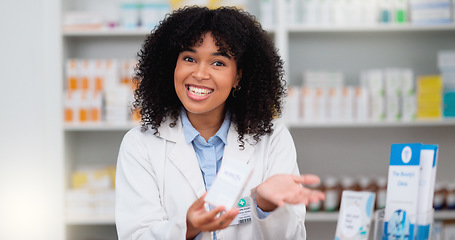 Image showing Friendly female chemist explaining the benefits of medicine. African American woman pharmacist listening to the symptoms of the customer. Health worker recommending a specific product to the client