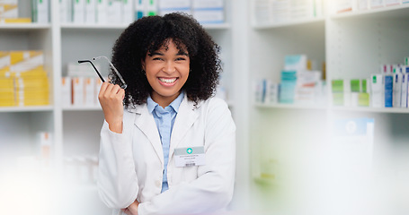 Image showing A friendly female pharmacist with a bright smile is about to help patients at the dispensary. Portrait of happy woman healthcare professional smiling at the pharmacy. A doctor taking off her glasses