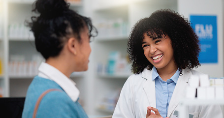 Image showing Young female chemist helping a customer to purchase prescription or chronic medication in the pharmacy. Young woman shopping for medicine and being assisted with advice by a doctor in a labcoat