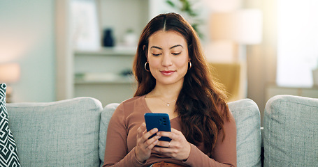 Image showing Phone, social media and happy woman texting on a dating app and smiling on the weekend at home on the couch. Smile, chatting and young girl loves typing a message on a social networking website