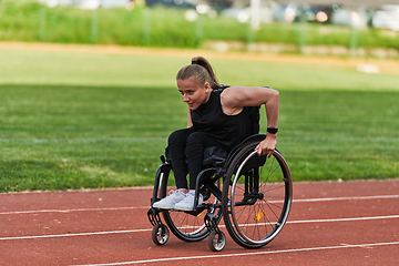 Image showing A woman with disablity driving a wheelchair on a track while preparing for the Paralympic Games