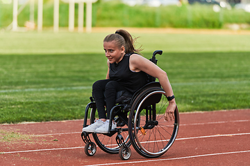 Image showing A woman with disablity driving a wheelchair on a track while preparing for the Paralympic Games