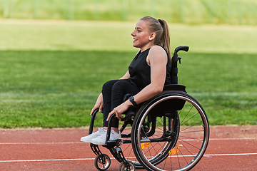 Image showing A woman with disablity driving a wheelchair on a track while preparing for the Paralympic Games