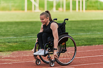 Image showing A woman with disablity driving a wheelchair on a track while preparing for the Paralympic Games