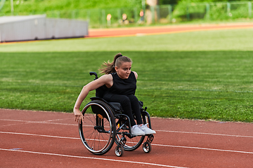 Image showing A woman with disablity driving a wheelchair on a track while preparing for the Paralympic Games