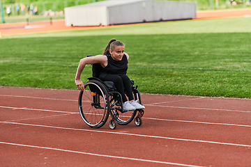 Image showing A woman with disablity driving a wheelchair on a track while preparing for the Paralympic Games