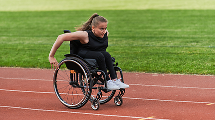 Image showing A woman with disablity driving a wheelchair on a track while preparing for the Paralympic Games