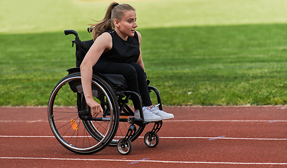 Image showing A woman with disablity driving a wheelchair on a track while preparing for the Paralympic Games