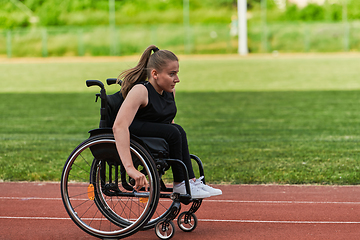 Image showing A woman with disablity driving a wheelchair on a track while preparing for the Paralympic Games