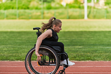 Image showing A woman with disablity driving a wheelchair on a track while preparing for the Paralympic Games