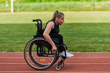 Image showing A woman with disablity driving a wheelchair on a track while preparing for the Paralympic Games