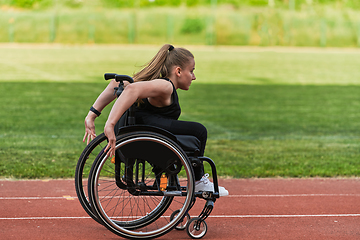 Image showing A woman with disablity driving a wheelchair on a track while preparing for the Paralympic Games