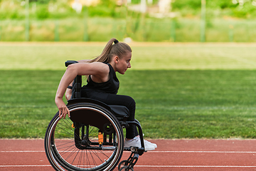 Image showing A woman with disablity driving a wheelchair on a track while preparing for the Paralympic Games