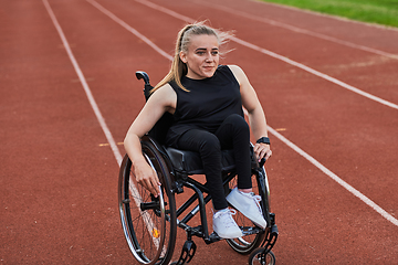 Image showing A woman with disablity driving a wheelchair on a track while preparing for the Paralympic Games