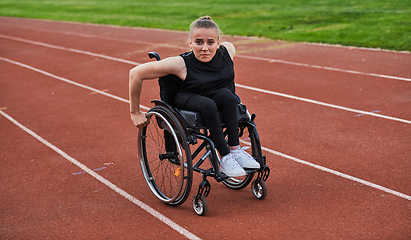 Image showing A woman with disablity driving a wheelchair on a track while preparing for the Paralympic Games