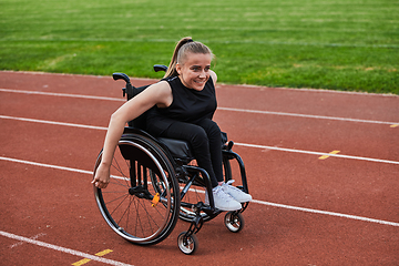 Image showing A woman with disablity driving a wheelchair on a track while preparing for the Paralympic Games