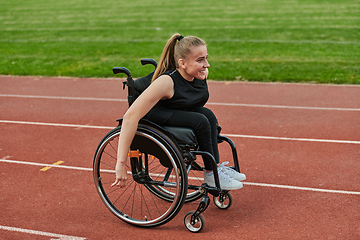 Image showing A woman with disablity driving a wheelchair on a track while preparing for the Paralympic Games