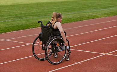 Image showing A woman with disablity driving a wheelchair on a track while preparing for the Paralympic Games