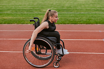 Image showing A woman with disablity driving a wheelchair on a track while preparing for the Paralympic Games