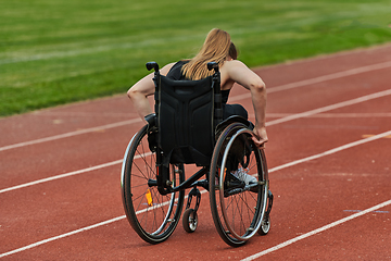 Image showing A woman with disablity driving a wheelchair on a track while preparing for the Paralympic Games