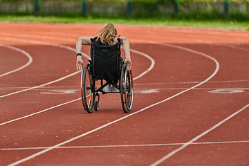 Image showing A woman with disablity driving a wheelchair on a track while preparing for the Paralympic Games