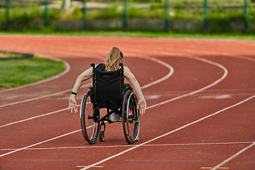 Image showing A woman with disablity driving a wheelchair on a track while preparing for the Paralympic Games