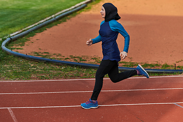 Image showing A muslim woman in a burqa sports muslim clothes running on a marathon course and preparing for upcoming competitions