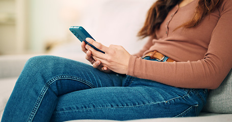 Image showing Sofa, home and hands typing on smartphone chat, social media or networking connection on mobile app, internet or house wifi. Teenager girl or woman with cellphone technology texting message in lounge