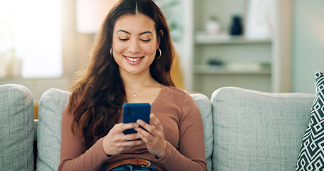 Image showing Phone, social media and happy woman texting on a dating app and smiling on the weekend at home on the couch. Smile, chatting and young girl loves typing a message on a social networking website