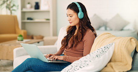 Image showing Online work, internet music and woman listening to an audio podcast while typing an email on the living room sofa of house. Remote entrepreneur working on laptop with radio on the web on the couch