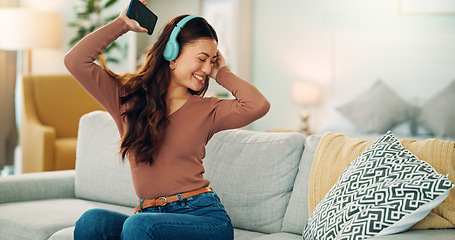 Image showing Phone, dancing and woman streaming music via headphones to relax with freedom on the weekend at home. Dance, excited and happy girl enjoys listening to a radio song or audio on an online subscription