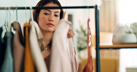 Image showing Fashion, shopping and customer with a woman in a store for retail while looking at clothes to buy or purchase. Buying, consumerism and choice with a female purchaser in a clothing boutique or shop