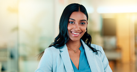 Image showing Successful female executive typing or reading an email. Confident business woman using a computer at work. Selective focus on beautiful lady sitting in an office chair, smiling.